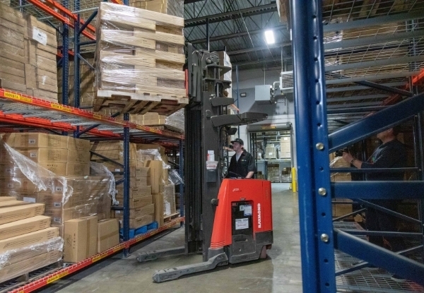 Warehouse worker using a forklift to move packages in our warehouse.