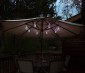 LED Bottle Light Bulbs w/ Integrated LED Fairy Lights - 50 Lumens - RGB Lights illuminating an  Table Unbrella