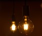 LED Filament Bulb - Gold Tint G30 LED Bulb with 6 Watt Filament LED - Dimmable: Shown In Open Fixture. 