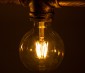 LED Filament Bulb - Gold Tint G30 LED Bulb with 6 Watt Filament LED - Dimmable: Shown Installed In Vintage Fixture. 