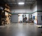 165W LED Linear High Bay Light - 4' - 21500 Lumens - 4000K/5000K: Single Fixture Illuminating Warehouse Station (Front View)